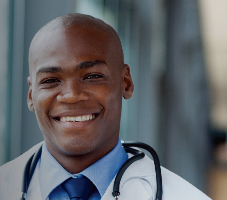 Physician smiling in a white coat with a stethoscope